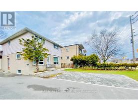 A real estate photo of a residential area with a Bay Street Group Inc. sign.