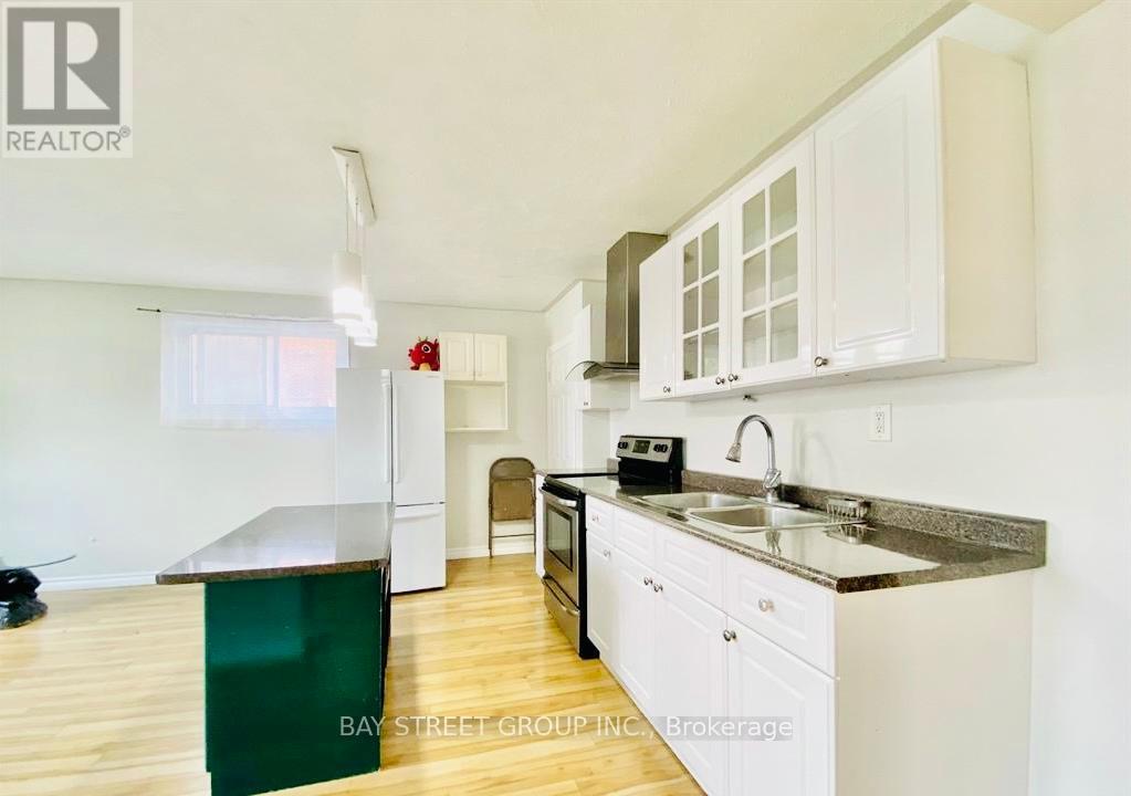 A kitchen with white cabinets and a green island.