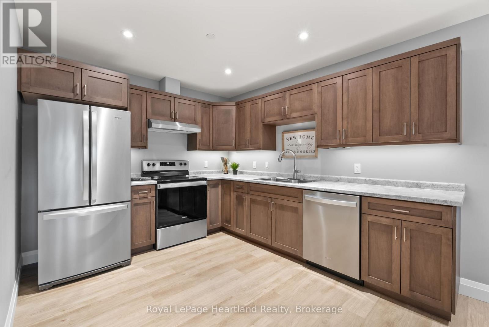 A kitchen with wooden cabinets and stainless steel appliances.