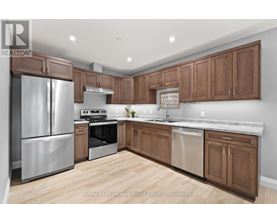 A kitchen with wooden cabinets and stainless steel appliances.