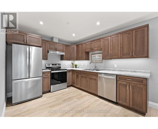 A kitchen with wooden cabinets and stainless steel appliances.
