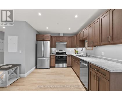 A kitchen with wooden cabinets and stainless steel appliances.