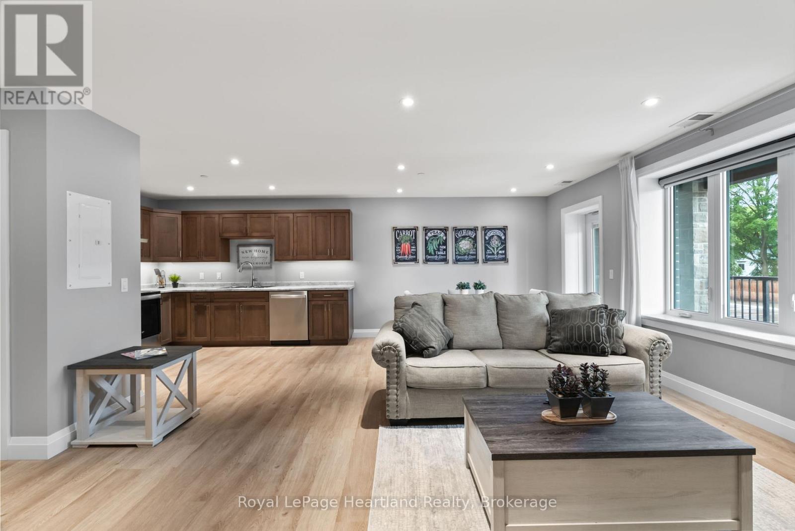 A modern living room with a grey couch and a wooden coffee table.