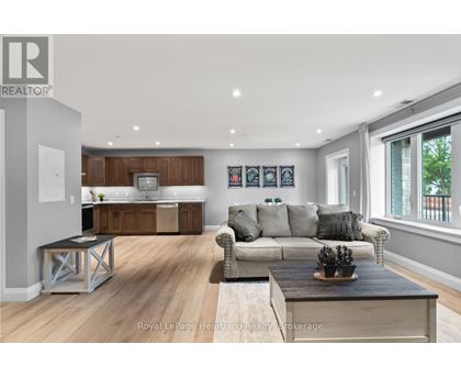 A modern living room with a grey couch and a wooden coffee table.