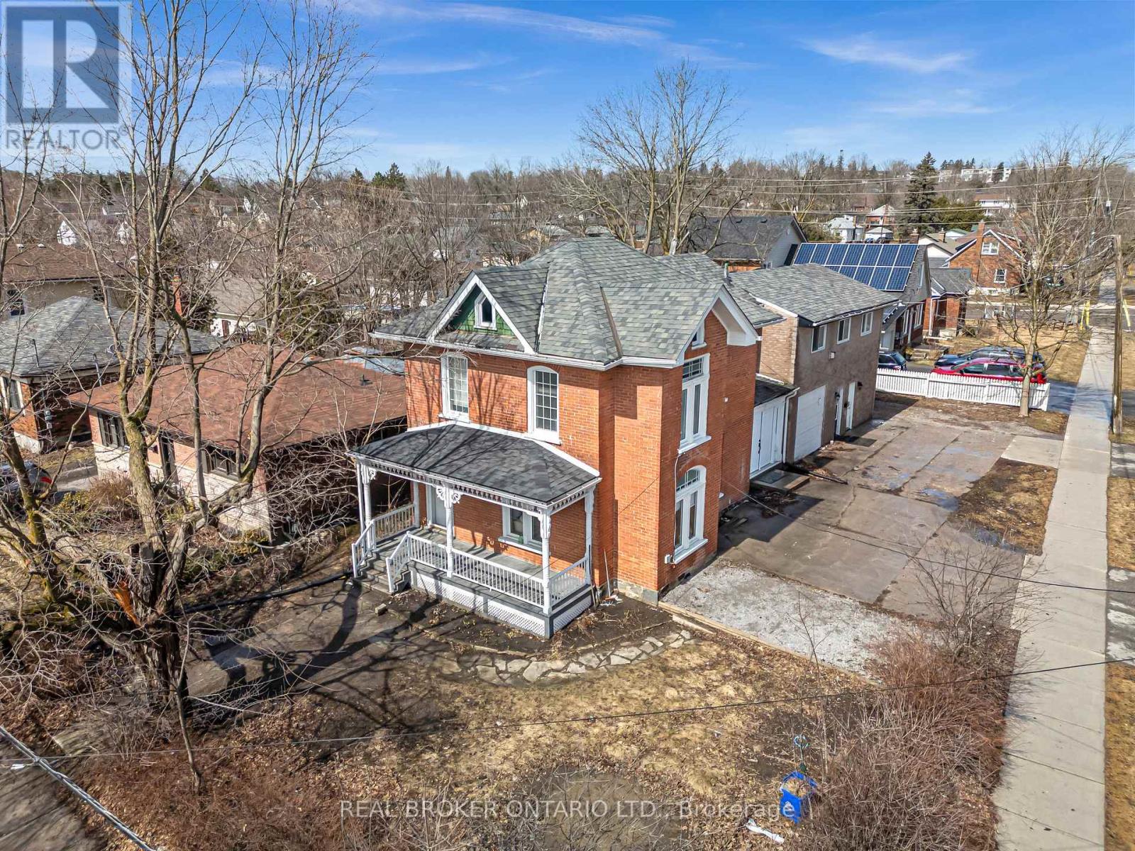 A house with a large front yard is for sale.