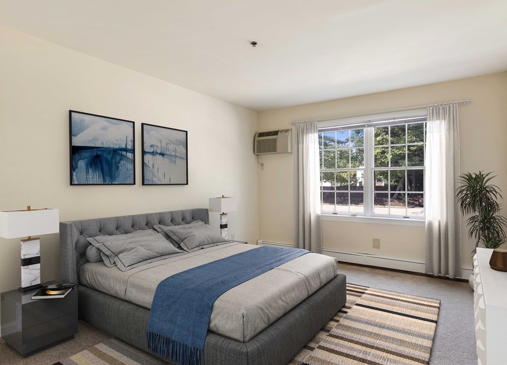 a bedroom with a bed and a large window