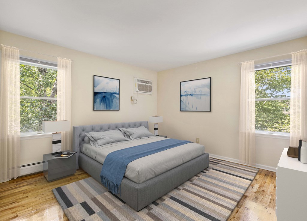 a bedroom with a bed and two windows