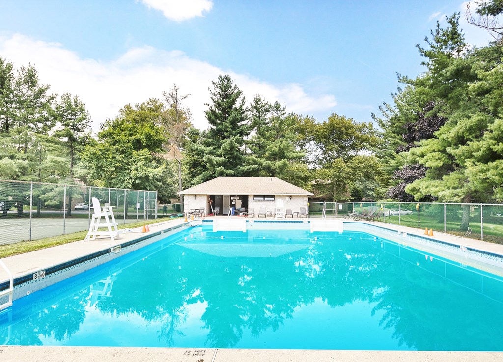 a swimming pool with a small pool house next to it