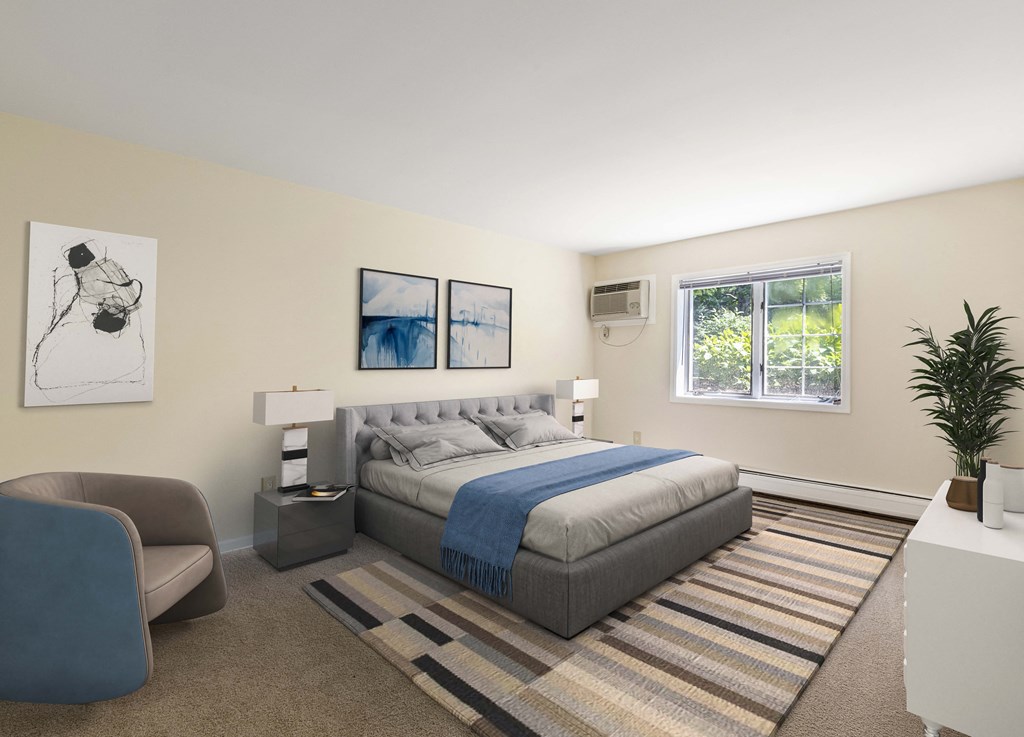 a bedroom with a bed and a couch and a window