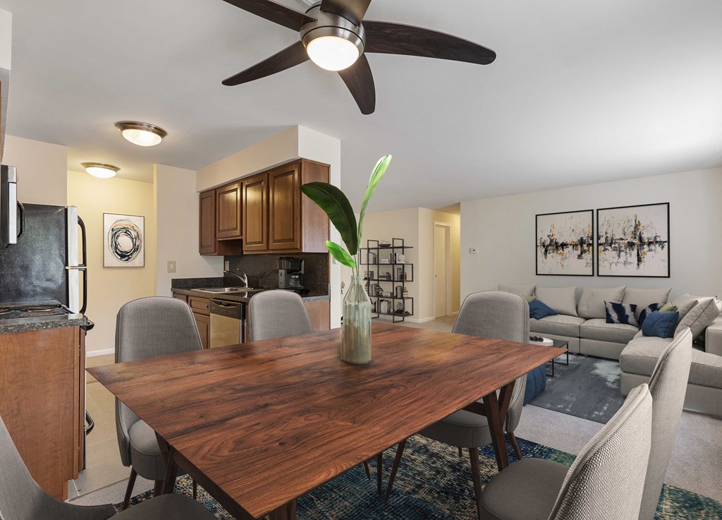 a living room and dining room with a wooden table