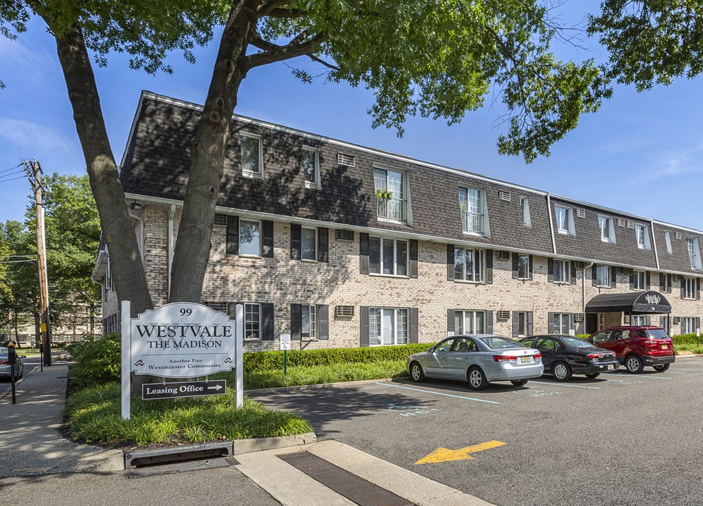 a large brick building with a sign in front of it