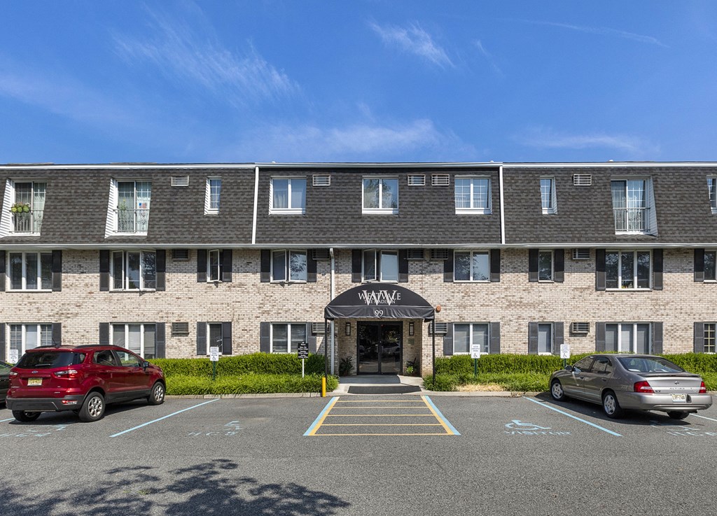 a large brick building with cars parked in front of it