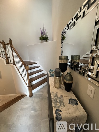 A kitchen with a counter and a staircase.