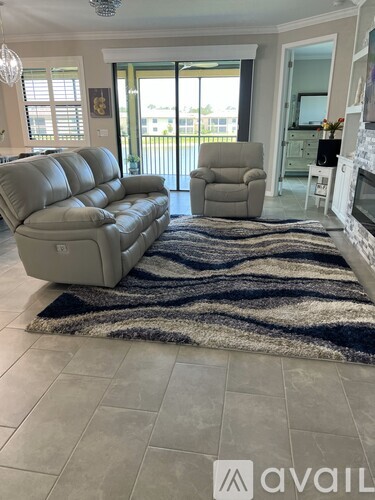 A living room with a grey leather sofa and armchair.