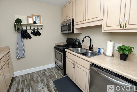 A kitchen with wooden cabinets and a black stove top oven.
