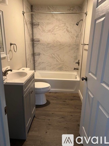 A bathroom with a toilet, sink, and bathtub.