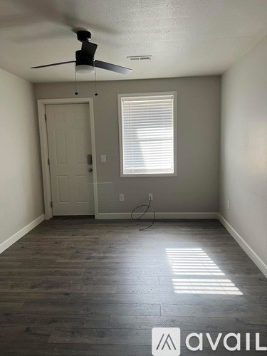 A room with a fan and a door.