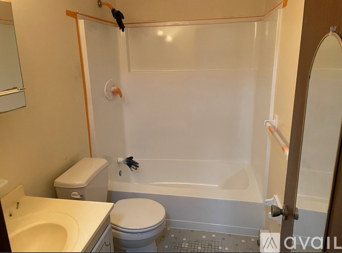 A bathroom with a toilet, sink, and bathtub.