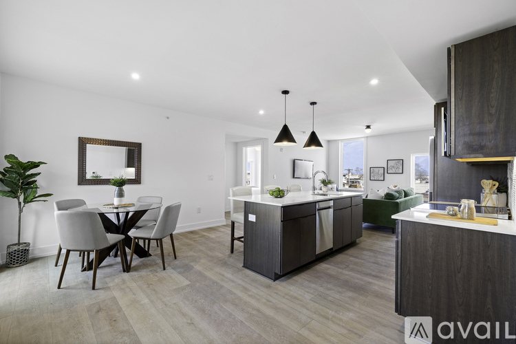 A modern kitchen with dark wood cabinets and a dining table with four chairs.