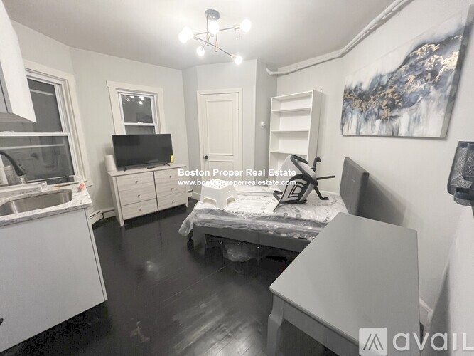 A bedroom with a bed, dresser, and mirror.