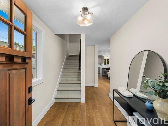A hallway with a staircase leading to the second floor.