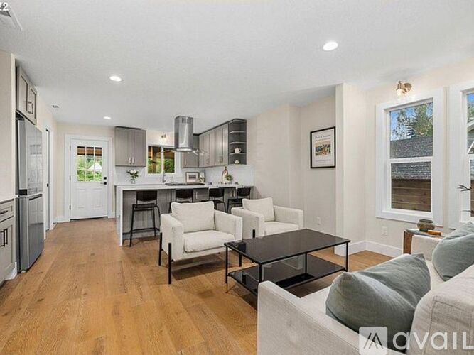 A modern kitchen with a dining table and chairs.