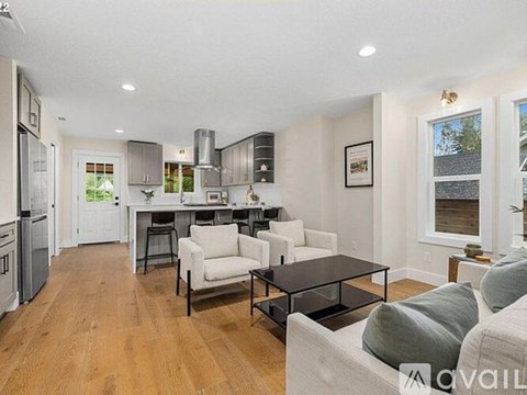 A modern kitchen with a dining table and chairs.