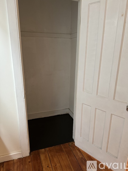 A white door with a black mat in front of it.