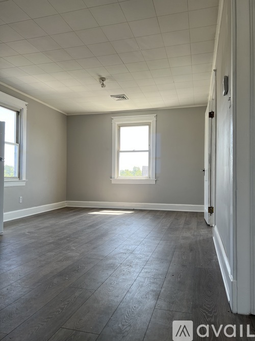 A room with a window and a door.