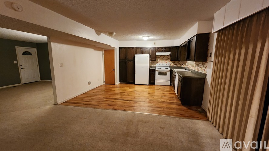 A kitchen area with a refrigerator, oven, and sink.