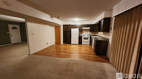 A kitchen area with a refrigerator, oven, and sink.