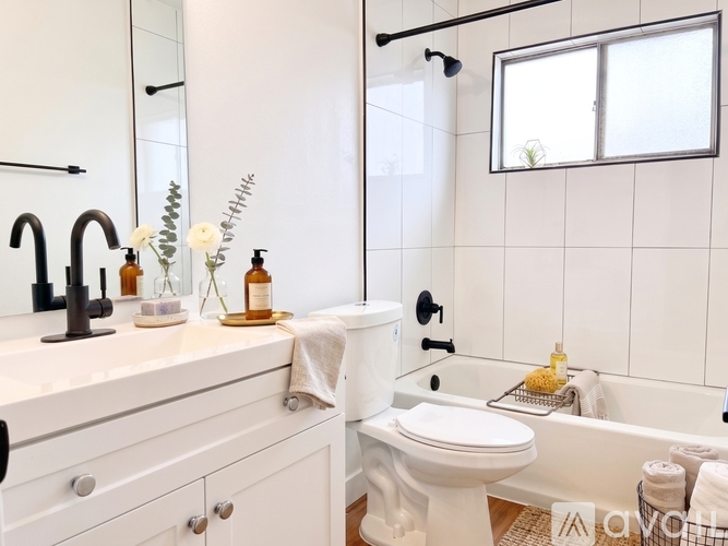 A spacious room with a ceiling fan and wooden flooring.