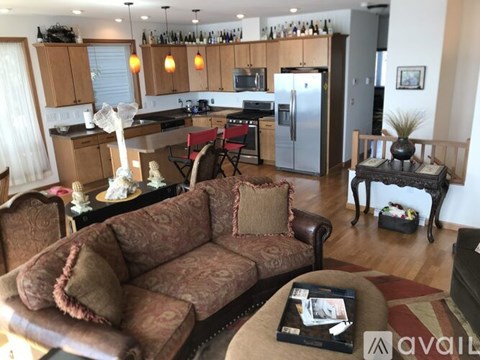 A living room with a brown couch and a coffee table.