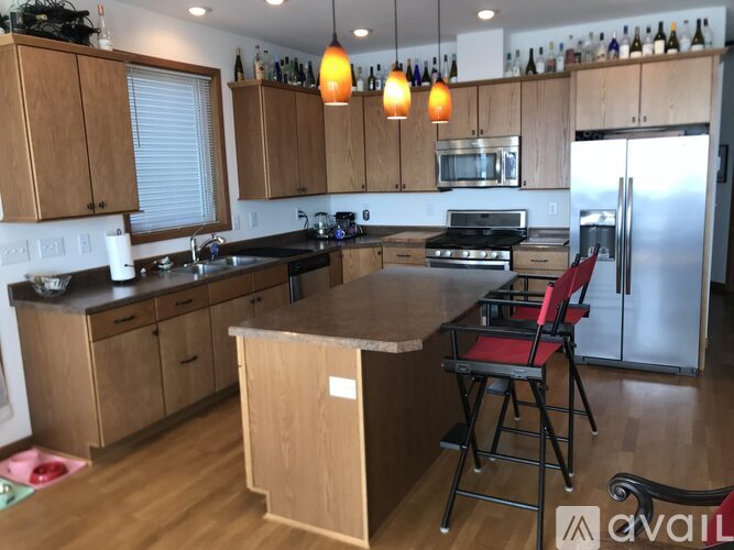 A kitchen with wooden cabinets and a black countertop.
