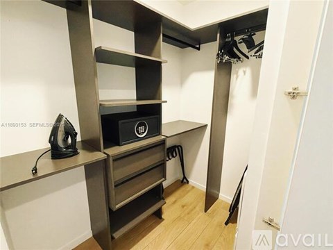 A room with a shelf, a speaker, and a hairdryer.