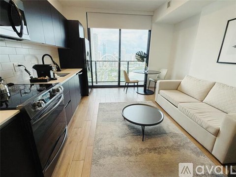 A modern kitchen with a black stove top oven and a black fridge freezer.