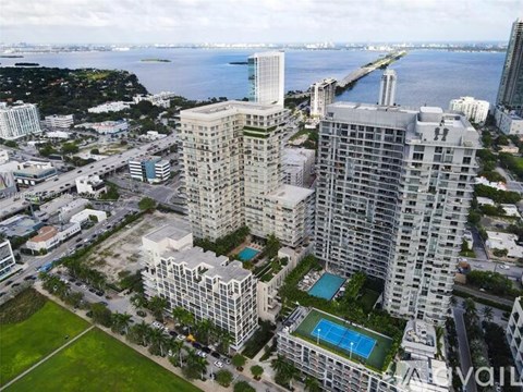 A large white building with a pool in the middle of it.