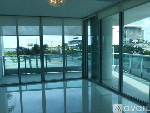 A room with a view of the outside through large windows.