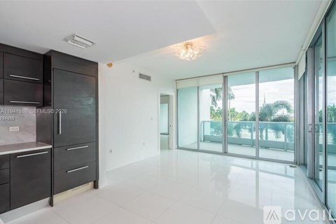 A kitchen with dark brown cabinets and a white countertop.