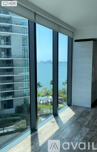 A modern room with a view of the cityscape through large windows.