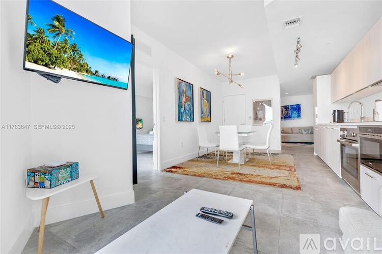 A modern living room with a flat screen TV mounted on the wall.