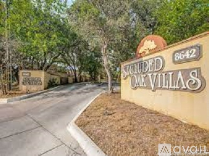 The image shows a sign for "Included Oaks Villas" with the number 8642 on it.