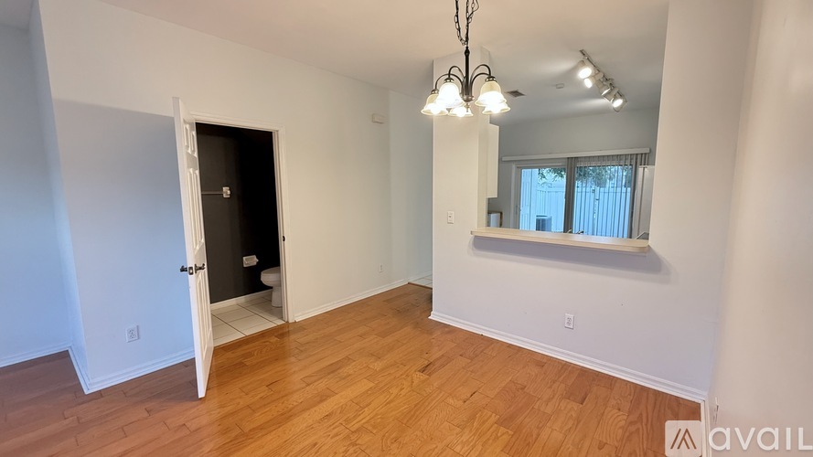 A room with wooden floors and a chandelier.