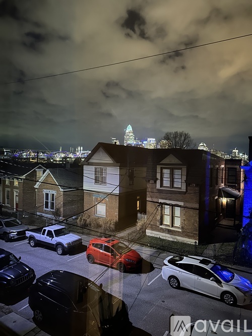 A street view of a neighborhood with cars parked on the side of the road.
