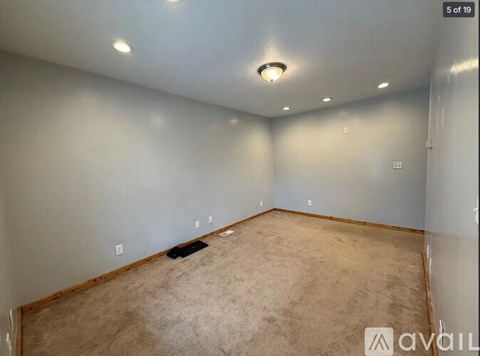 A room with a carpeted floor and a ceiling light.