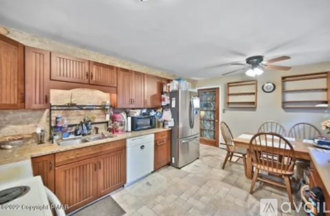 A kitchen with wooden cabinets and a refrigerator.