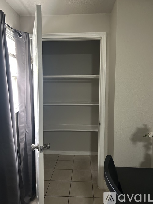 A room with a door and a chair.