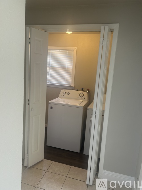A white bathroom with a toilet and sink.