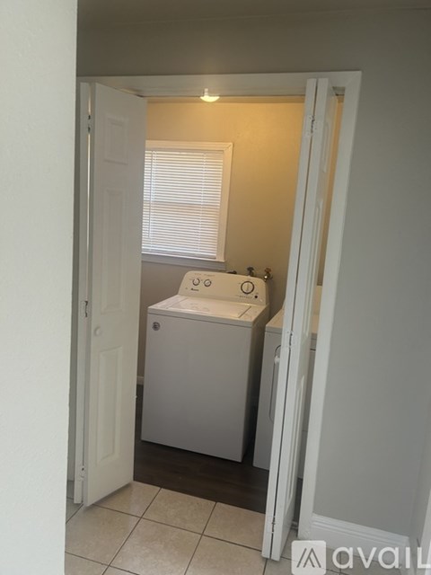 A white bathroom with a toilet and sink.