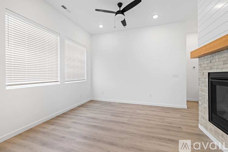 A room with a fireplace and a ceiling fan.